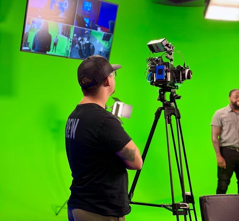 Blue Room Media production crew filming visual effects footage on a green screen stage